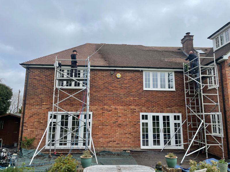 Roof cleaning carried out safely from scaffold towers by The Roof Moss Cleaners in Wokingham